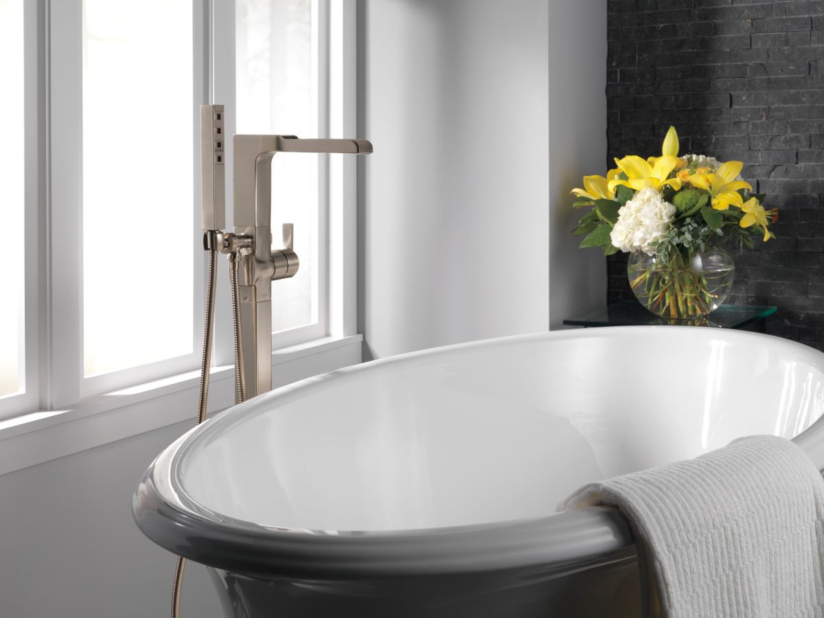 DELTA Ara Single Handle Floor Mount Channel Spout Tub Filler Trim with Hand Shower — Stainless